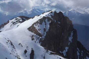 The contrast between the limestone rock and the white of the snow.