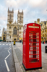 London, UK - 04 2015: An iconic red phone boot near Westminster Abbey