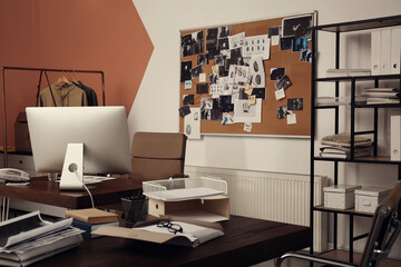 Modern detective office with computer and board