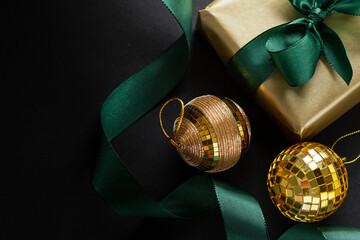 Wrapped gift with baubles on dark background