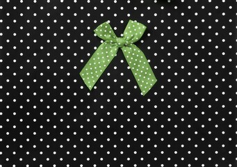 Silk bow isolated on a black background with white dots