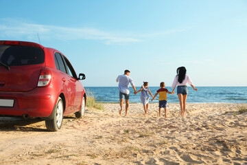 Family running on sandy beach. Summer trip