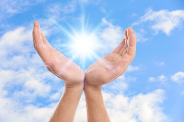Bright light in hands, closeup. Solar energy concept