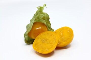 Physalis, cape gooseberry fruit. Ripe fruit with beautiful, rich colors. Cutted fruit with visible seeds.