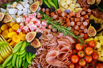 Variety or assortment of cheese, fruits and deli.