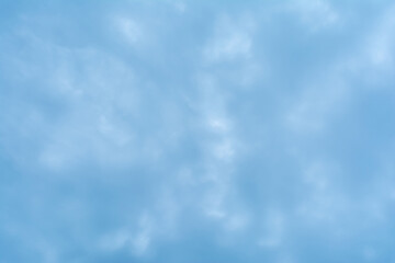 Abstract background based on clouds of uncertain shape in light blue sky
