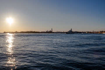 The sun sets over the Venetian lagoon and the distant San Giorgio Maggiore island
