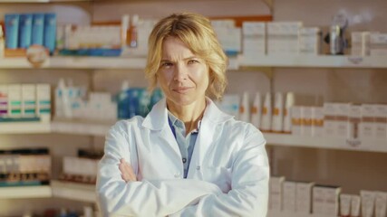 Close up attractive young woman in uniform pharmacist at pharmacy stand look at camera hold tablet computer. Diagnosis young pharmaceutics store job healthy medicine. Slow motion