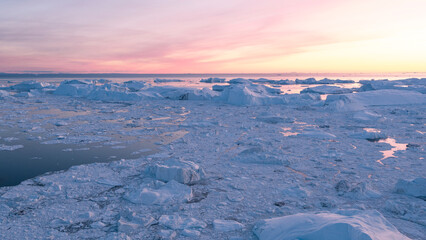 Iceberg from glacier in arctic nature landscape on Greenland. Aerial photo drone footage of icebergs in Ilulissat icefjord. Affected by climate change and global warming.