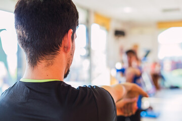 Young sportwears at the gym.   Back of a Personal Trainer in a gym.  Concept of sport and recreation.