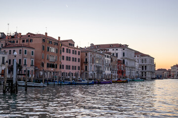Fototapeta premium Views of Venetian architecture and buildings alongside the Grand Canal against a pastel sunset sky 