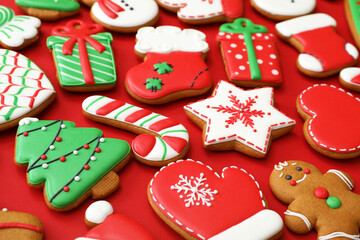 Fototapeta na wymiar Different Christmas gingerbread cookies on red background, closeup