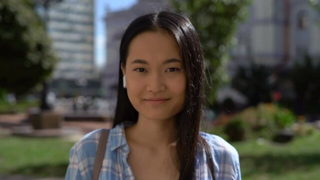 portrait of a beautiful woman. beautiful young asian woman stands on the street 4K