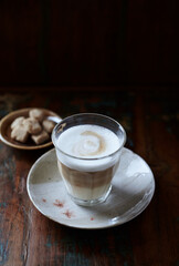 Glass of Latte Macchiato. Rustic wooden background. Close up.	