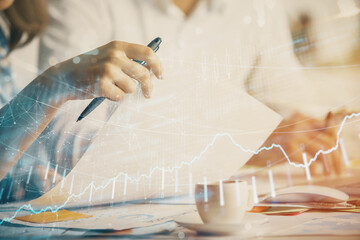 Double exposure of forex graph drawing over people taking notes background. Concept of financial analysis