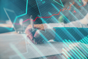 Double exposure of forex chart drawing over people taking notes background. Concept of financial analysis