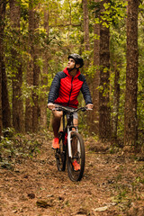 Fototapeta na wymiar Cyclist in the jungle. Sportsman in the jungle. Alternative sports and outdoor concept.