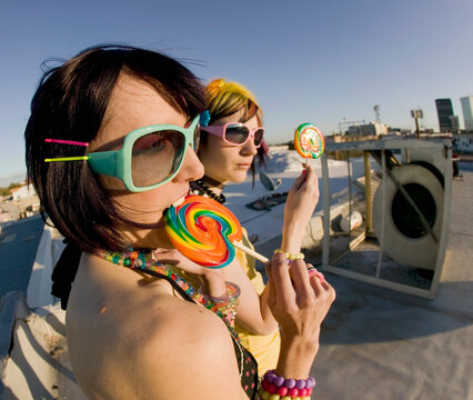 Fun girls on the roof with lollipops