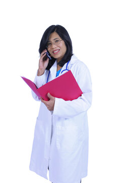 Asian Female Doctor Talking On Cell Phone And Holding Files