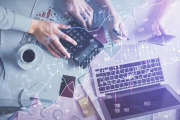 Double exposure of man and woman working together and financial chart hologram drawing. market...