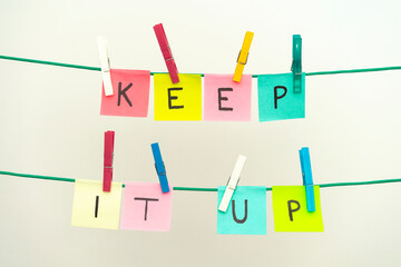 COLOR STICKY NOTES WITH LETTERS ON THE CLOTHES LINE SPELLING KEEP IT UP. MOTIVATING SENTENCES...