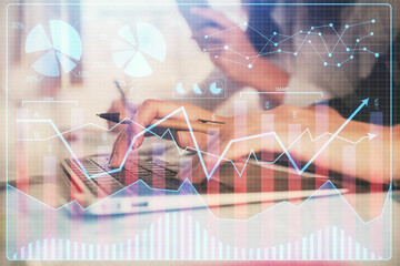 Multi exposure of woman hands typing on computer and financial graph hologram drawing. Stock market...