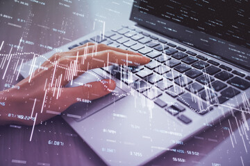 Double exposure of woman hands typing on computer and forex chart hologram drawing. Stock market analysis concept.