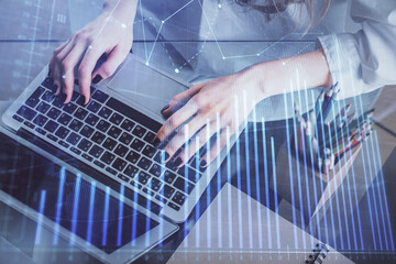 Double exposure of woman hands typing on computer and forex chart hologram drawing. Stock market invest concept.