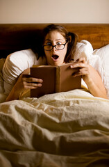 Woman Reading in Bed