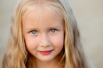 Portrait of a beautiful little blue-eyed blonde girl