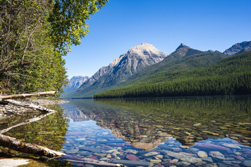 Fototapeta na wymiar Clear Reflection of Mountains in Lake Bowman in Glacier National Park