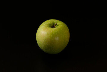 Green apple isolated on black background
