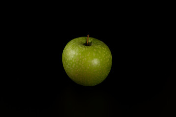 Green apple isolated on black background