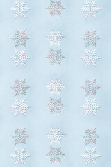 Christmas pattern silver and white snowflakes on pastel blue background