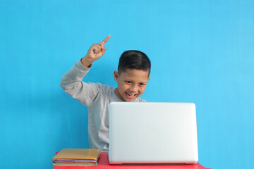 portrait of school boy with happy expression while studying. excited feeling