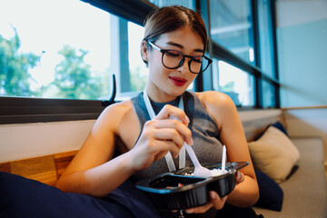 Business woman wearing eyeglasses enjoy lunch box set in office.