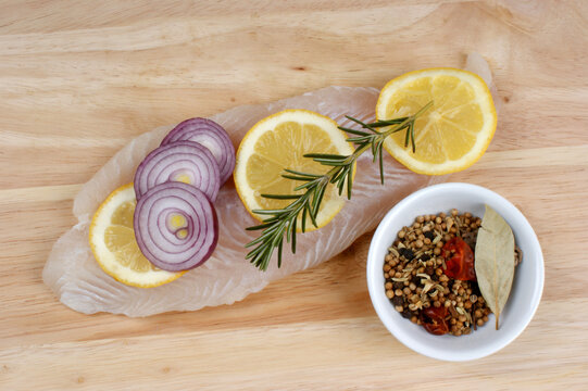 raw vietnamese river cobbler fillet on a timber board