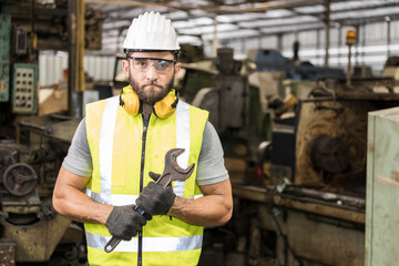 Portrait of male bearded engineer in the factory.