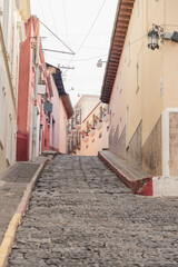 Fototapeta na wymiar Ancient and romantic stone street of colonial city -Streets of Quetzaltenango in the historic center of the city