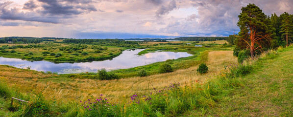 Gorgeous panoramic landscape of an incredible evening on the bank of a beautiful river
