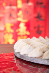 Pack the festive dumplings to be cooked in front of a festive red background