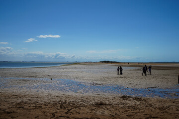 people walking on the beach in the late afternoon at Wellington Point, Queensland