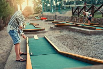 Kids playing mini golf on the territory of the hotel