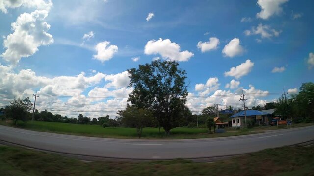 View Out The Side of car thailand cloudy sky and tree with a lot of cars at other side  4k