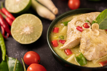 Green curry made with chicken, chili, and basil, with tomato, lime, kaffir lime leaves and garlic.