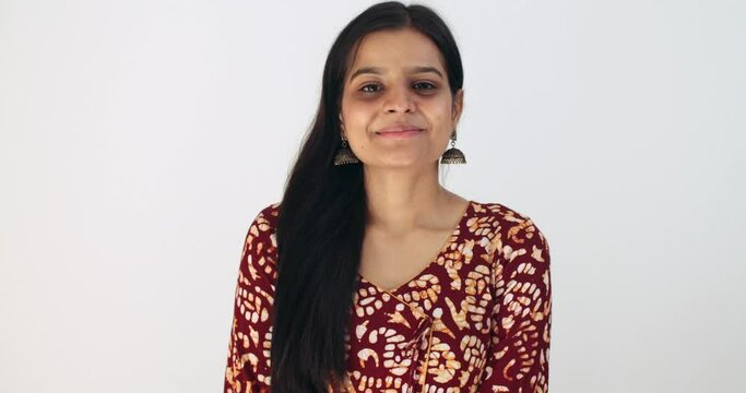 Indian woman completely pleasantly surprised taken aback in awesome disbelief good news of success victory win raises both her hands in the air on top and stares down the camera still in denial smiles
