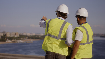 Contactors in masks talking on construction site