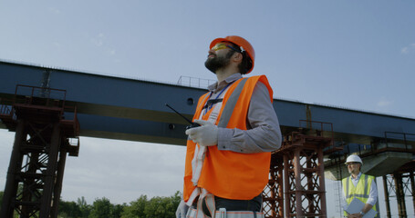 Bearded foreman controlling construction process