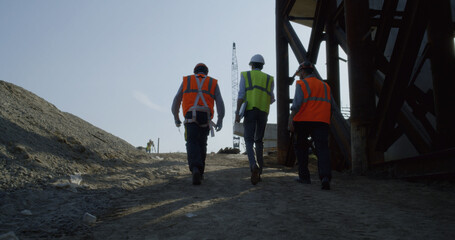 Inspectors walking on bridge construction site