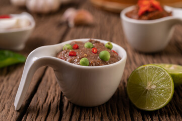 Nam phrik kapi  with Chili and Lemon on wooden floor.